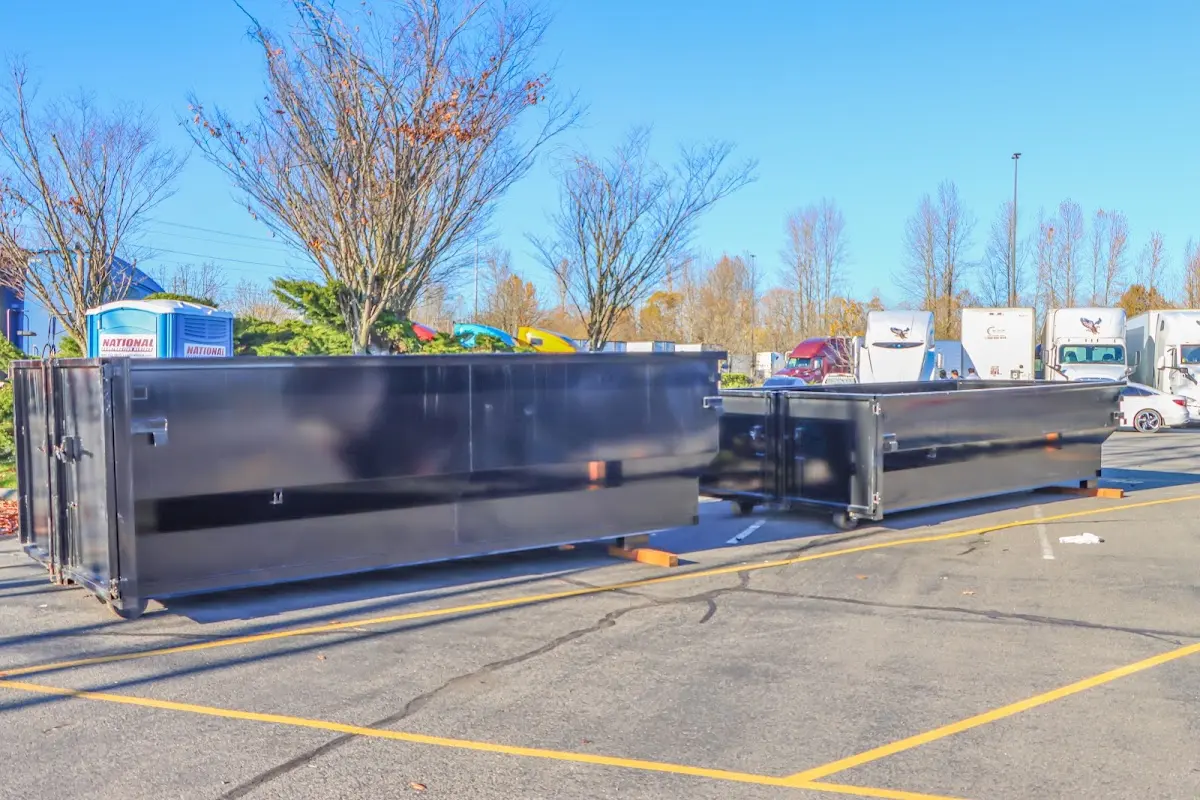 Professional dumpster rental service with roll-off container on residential driveway in Olmsted Falls